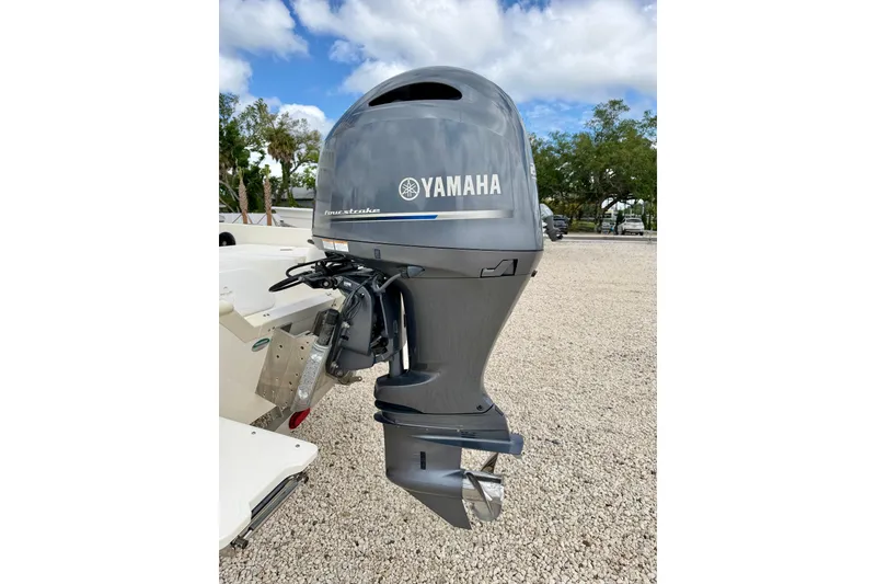Slide: The Image of 2018 Skeeter SX2250 with Yamaha outboard motor in a gravel lot. - 37