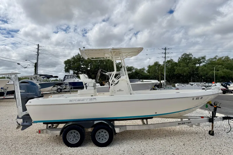 Slide: The Image of 2018 Skeeter SX2250 boat on trailer under cloudy sky, parked in a lot. - 4