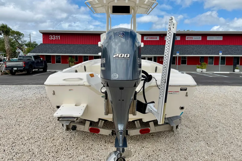 Slide: The Image of 2018 Skeeter SX2250 boat with Yamaha 200 engine, parked on gravel lot. - 6