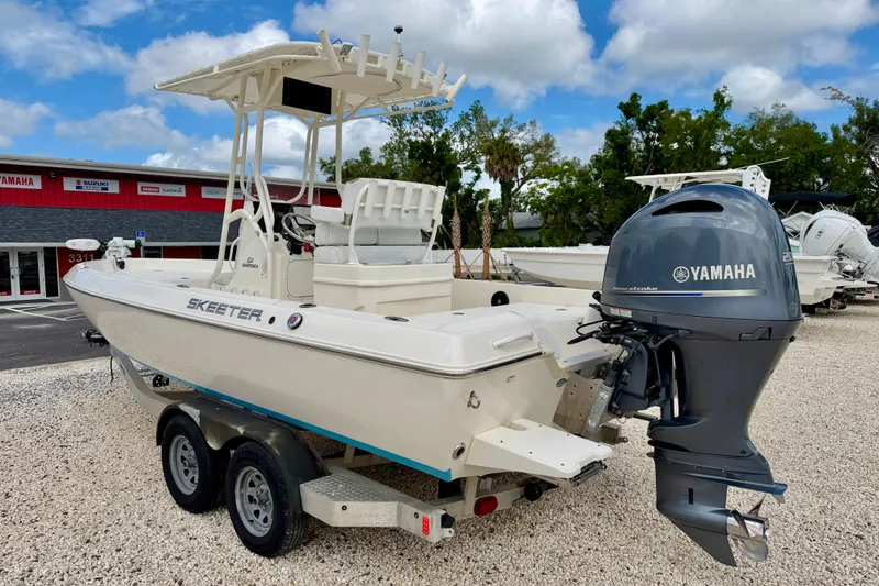 Slide: The Image of 2018 Skeeter SX2250 boat with Yamaha outboard motor on a trailer, parked outdoors. - 7