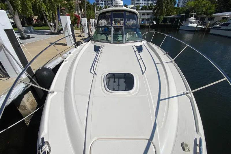 Slide: The Image of 2008 Sea Ray Sundancer 330 docked, showcasing sleek design and spacious deck. - 13