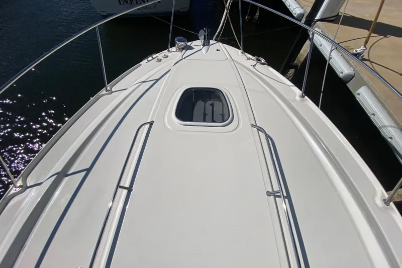 Slide: The Image of 2008 Sea Ray Sundancer 330 boat deck with hatch, docked in sunlight. - 14