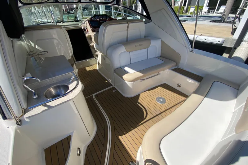Slide: The Image of 2008 Sea Ray Sundancer 330 interior with seating, sink, and wood flooring. - 26