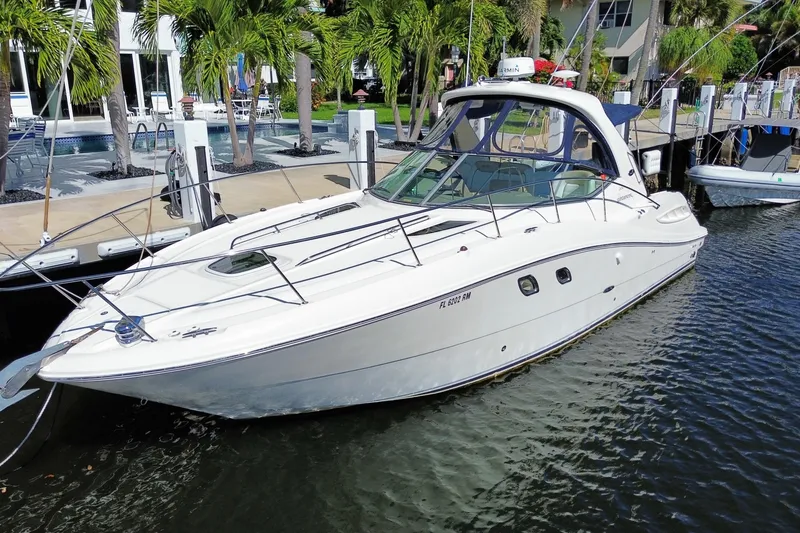 Slide: The Image of 2008 Sea Ray Sundancer 330 docked near palm trees and waterfront homes. - 3