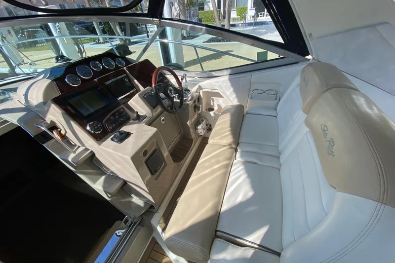 Slide: The Image of 2008 Sea Ray Sundancer 330 cockpit with beige seating and modern dashboard controls. - 31
