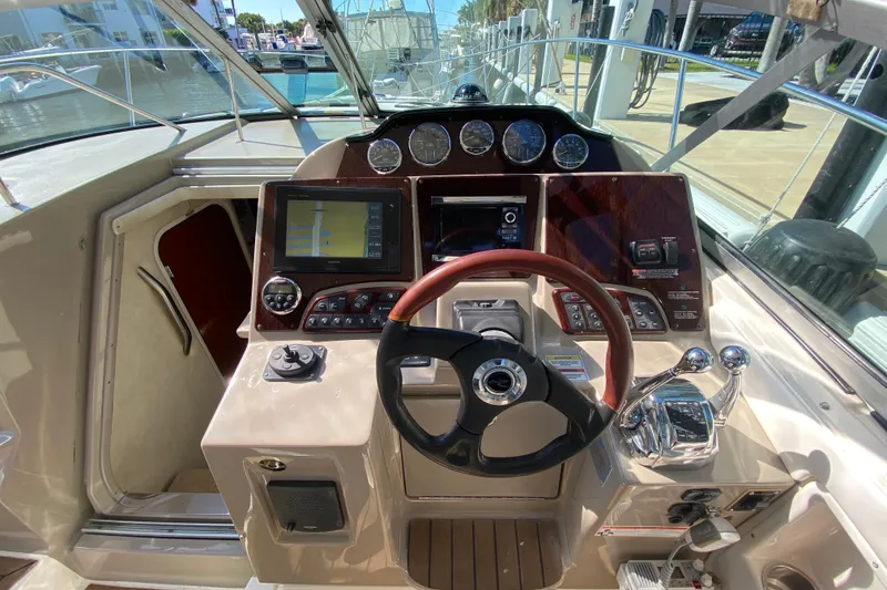Slide: The Image of 2008 Sea Ray Sundancer 330 helm with navigation controls and steering wheel. - 33