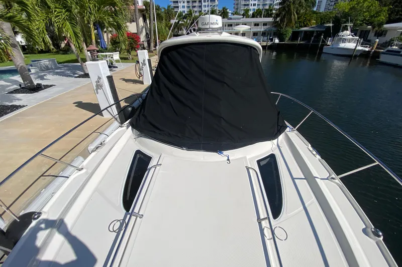 Slide: The Image of 2008 Sea Ray Sundancer 330 yacht docked, covered cockpit, sunny marina setting. - 53