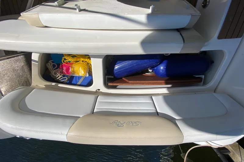 Slide: The Image of 2008 Sea Ray Sundancer 330 storage compartment with ropes and fenders on deck. - 55
