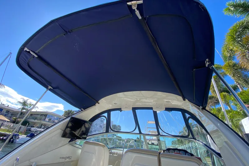 Slide: The Image of 2008 Sea Ray Sundancer 330 boat interior with blue canopy and clear sky background. - 57