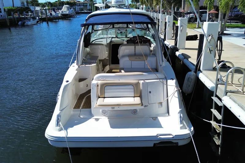 Slide: The Image of 2008 Sea Ray Sundancer 330 docked, showcasing spacious deck and seating area. - 60