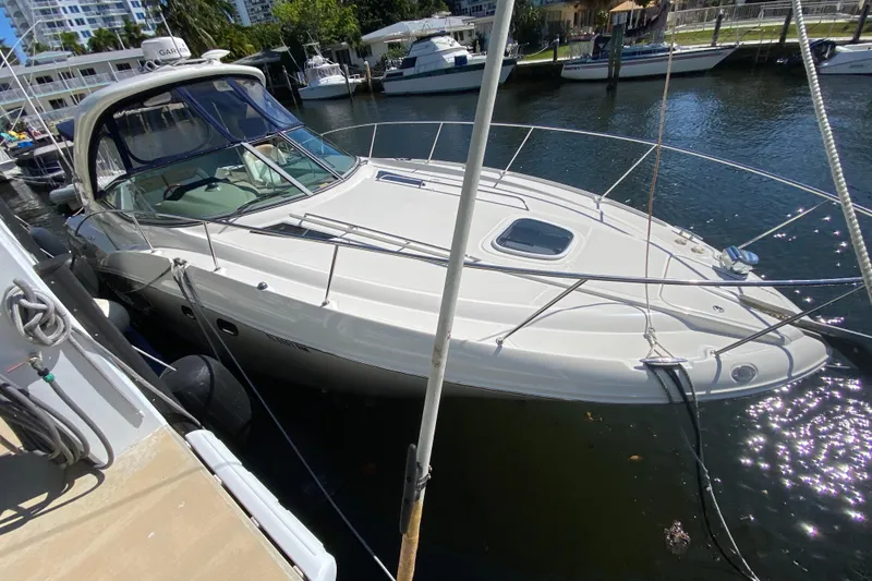 Slide: The Image of 2008 Sea Ray Sundancer 330 docked in a sunny marina, showcasing sleek design and luxury. - 7