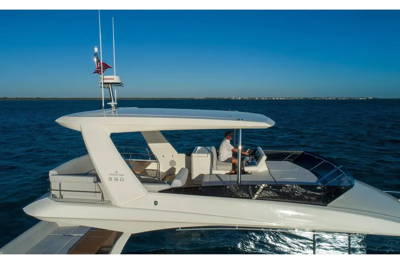 Slide: The Image of Interior of 2020 Prestige 590 yacht with modern kitchen and spacious seating area. - 11