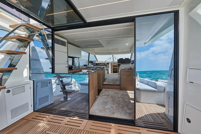 Slide: The Image of Luxurious interior of 2020 Prestige 590 yacht with ocean view, plush seating, and modern decor. - 14
