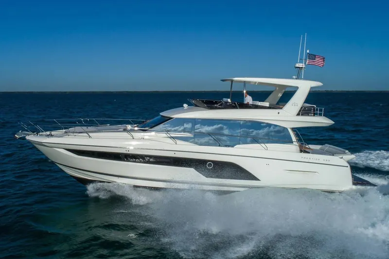Slide: The Image of Prestige 590 yacht cruising on open water, 2020 model. - 5