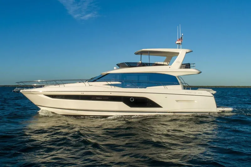 Slide: The Image of Luxurious interior of 2020 Prestige 590 yacht with modern kitchen and panoramic windows. - 9