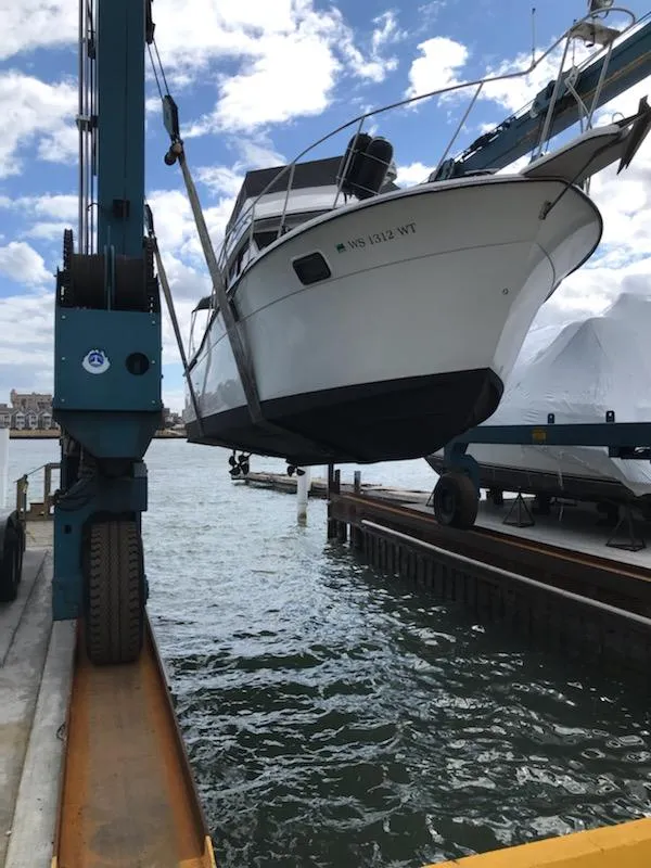 Slide: The Image of 1989 Carver 32 Convertible boat being lifted from water. - 1