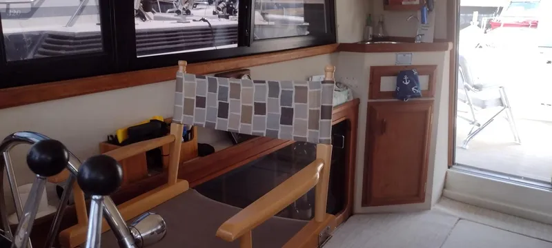 Slide: The Image of Interior of a 1989 Carver 32 Convertible yacht with wooden furnishings. - 15