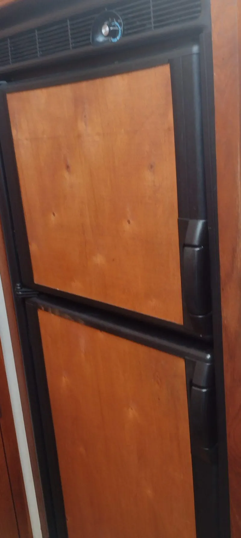 Slide: The Image of Wood-paneled refrigerator in 1989 Carver 32 Convertible. - 23