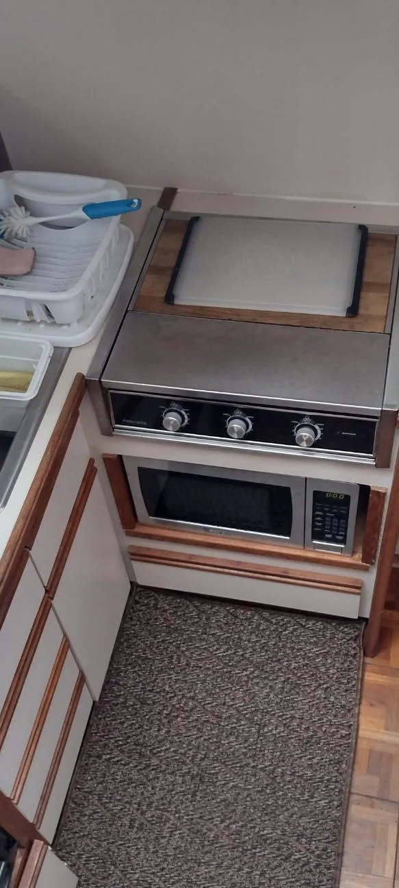 Slide: The Image of Kitchen area in a 1989 Carver 32 Convertible boat. - 24