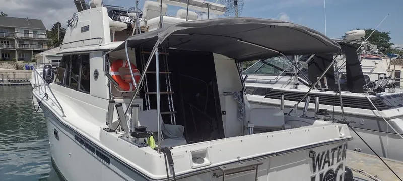 Slide: The Image of 1989 Carver 32 Convertible yacht docked at marina. - 3