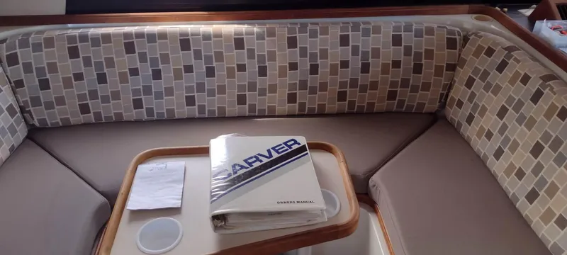 Slide: The Image of Interior of 1989 Carver 32 Convertible with seating area and manual. - 31
