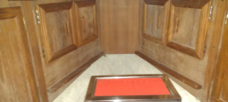 Slide: The Image of 1989 Carver 32 Convertible interior with wooden cabinetry. - 32