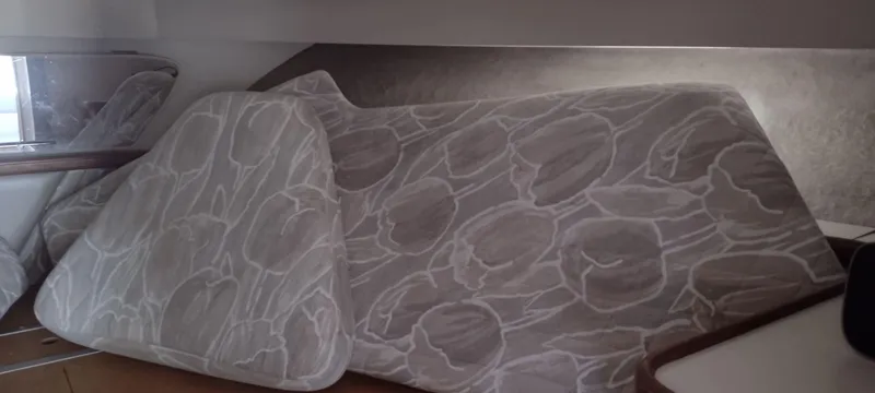 Slide: The Image of Interior of a 1989 Carver 32 Convertible with upholstered cushions. - 34