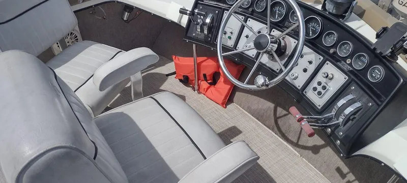 Slide: The Image of Interior of a 1989 Carver 32 Convertible boat with steering console. - 39