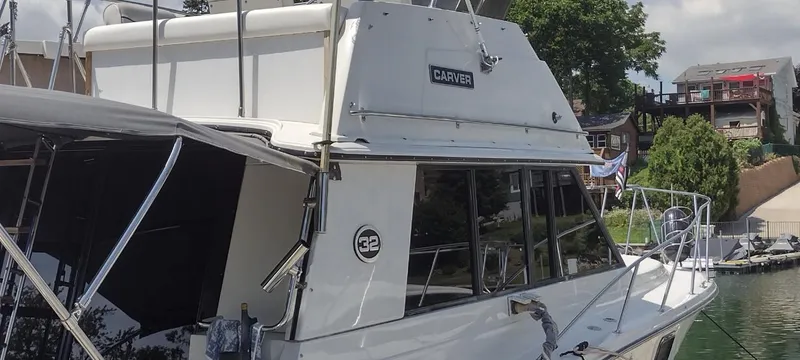 Slide: The Image of 1989 Carver 32 Convertible yacht docked at marina. - 7