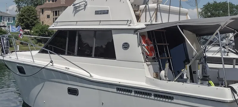 Slide: The Image of 1989 Carver 32 Convertible boat docked at harbor. - 8