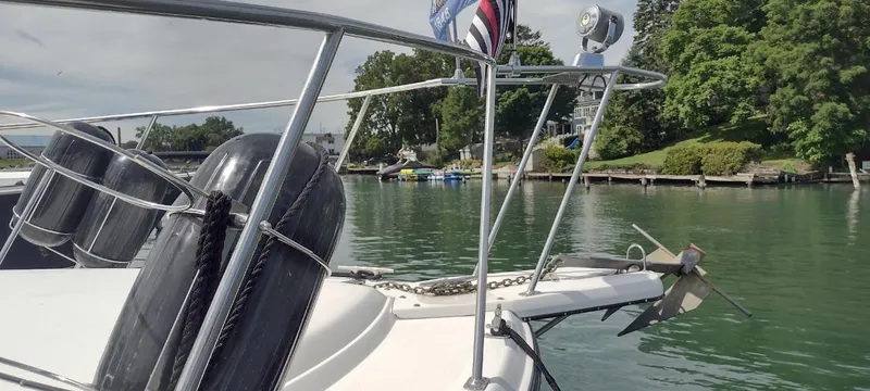 Slide: The Image of 1989 Carver 32 Convertible boat at lakeside with green trees. - 9