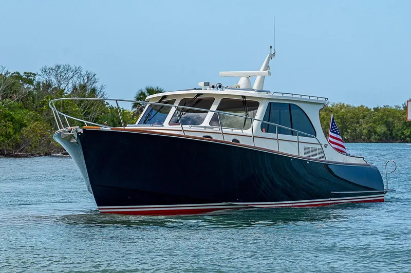 Slide: The Image of 2021 Hinckley Talaria 43 yacht cruising on calm waters with American flag. - 10