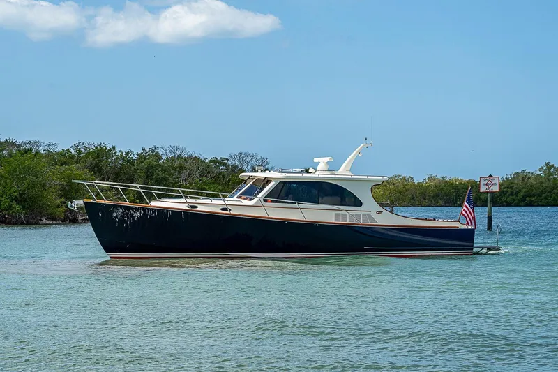 Slide: The Image of 2021 Hinckley Talaria 43 yacht cruising in clear waters under a blue sky. - 12