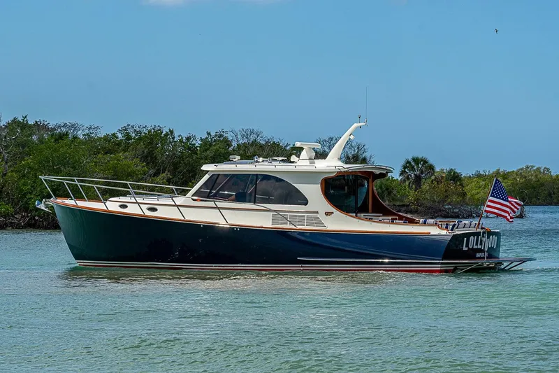 Slide: The Image of 2021 Hinckley Talaria 43 yacht cruising on calm waters with American flag. - 15