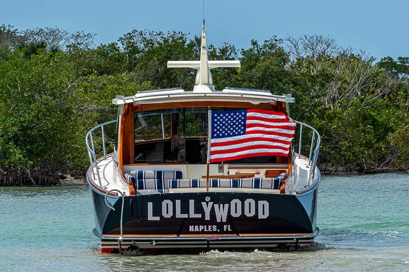 Slide: The Image of Hinckley Talaria 43 yacht, 2021 model, with American flag, in scenic waterway. - 19
