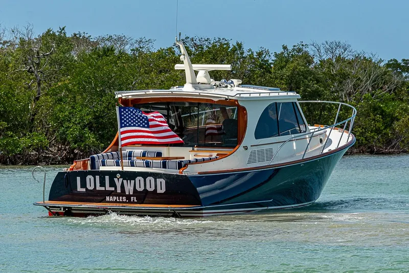 Slide: The Image of 2021 Hinckley Talaria 43 yacht cruising in Naples, Florida waters with American flag. - 20