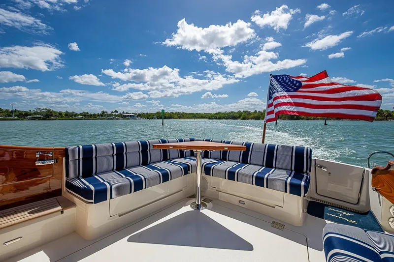 Slide: The Image of Hinckley Talaria 43 yacht deck with striped seating and American flag, 2021 model. - 27