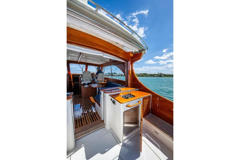 Slide: The Image of 2021 Hinckley Talaria 43 yacht interior with wooden accents and ocean view. - 29