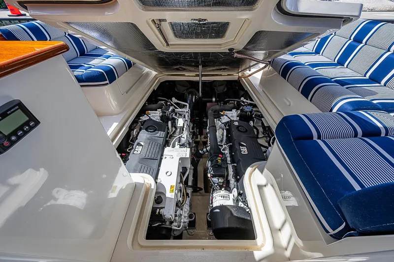 Slide: The Image of Engine compartment of 2021 Hinckley Talaria 43 with striped seating and dual engines. - 34
