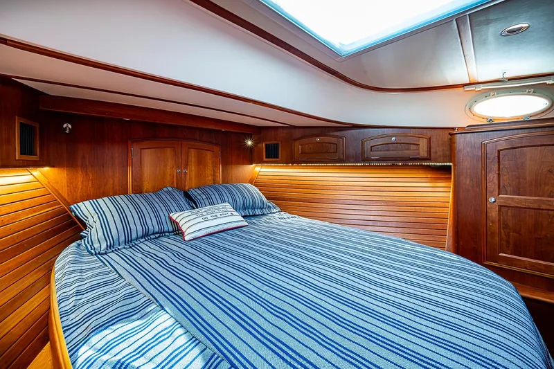 Slide: The Image of Luxurious cabin interior of 2021 Hinckley Talaria 43 yacht with striped bedding. - 36