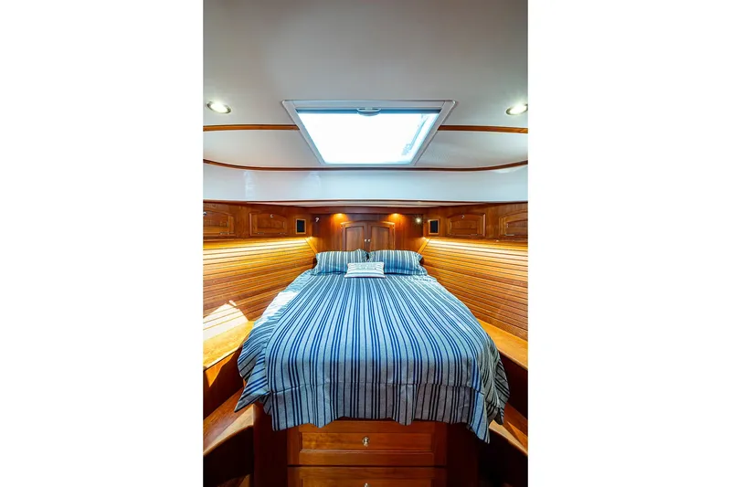 Slide: The Image of Luxurious cabin interior of 2021 Hinckley Talaria 43 yacht with striped bedding. - 38