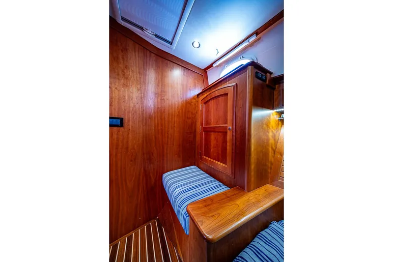 Slide: The Image of Interior of 2021 Hinckley Talaria 43 yacht with wooden paneling and striped seating. - 45