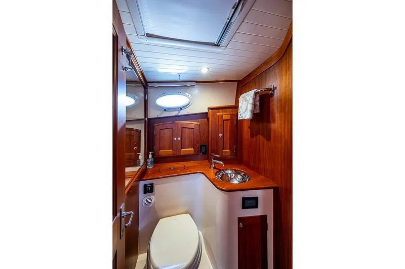Slide: The Image of Luxurious 2021 Hinckley Talaria 43 yacht bathroom with wood finish and modern fixtures. - 46