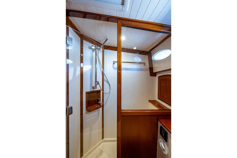 Slide: The Image of Luxurious shower area in 2021 Hinckley Talaria 43 yacht, featuring elegant wood accents. - 47