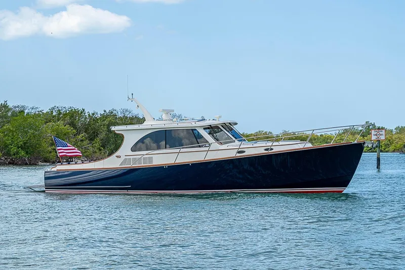 Slide: The Image of 2021 Hinckley Talaria 43 yacht cruising on calm waters with American flag. - 5