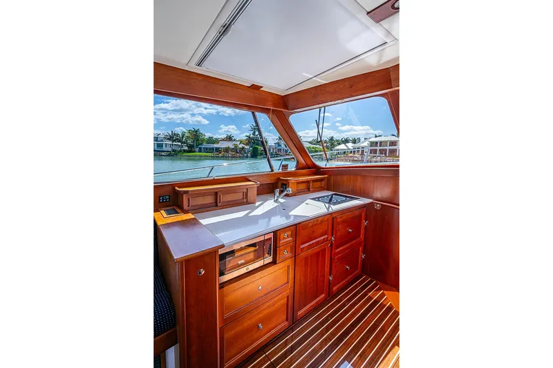 Slide: The Image of Luxurious 2021 Hinckley Talaria 43 yacht interior with elegant wood cabinetry and waterfront view. - 54