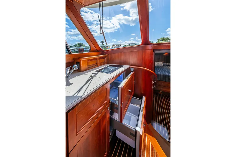 Slide: The Image of Interior of 2021 Hinckley Talaria 43 yacht with elegant wood cabinetry and modern appliances. - 57