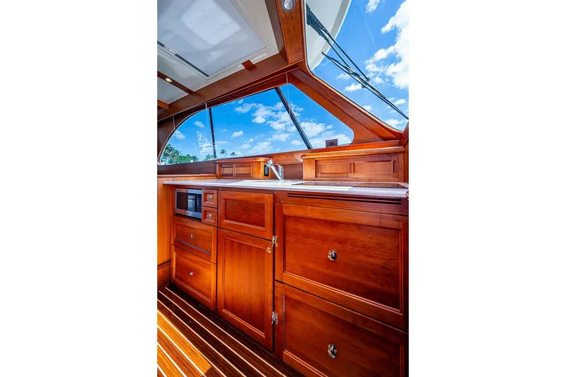 Slide: The Image of Luxurious wooden interior of 2021 Hinckley Talaria 43 yacht with clear sky view. - 58