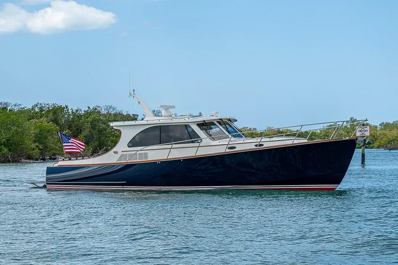 Slide: The Image of 2021 Hinckley Talaria 43 yacht cruising on calm waters with American flag. - 6