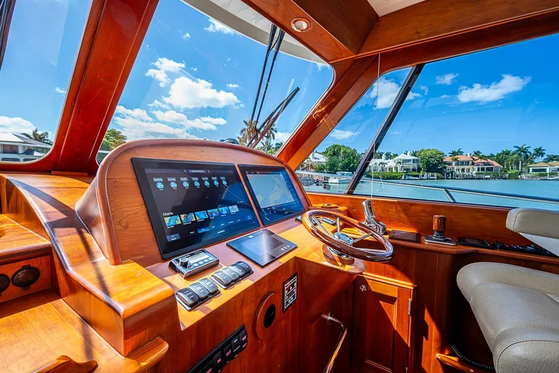 Slide: The Image of Helm of 2021 Hinckley Talaria 43 yacht with modern navigation screens and wooden finish. - 60